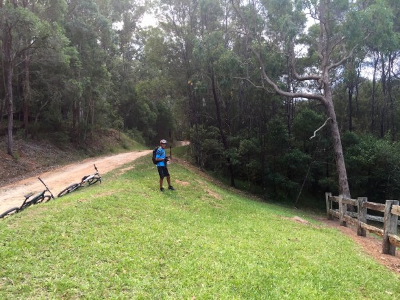 Paul cogitating joining the folk in the cemetery or the less attractive option of riding his bike up the last 2km ascent 